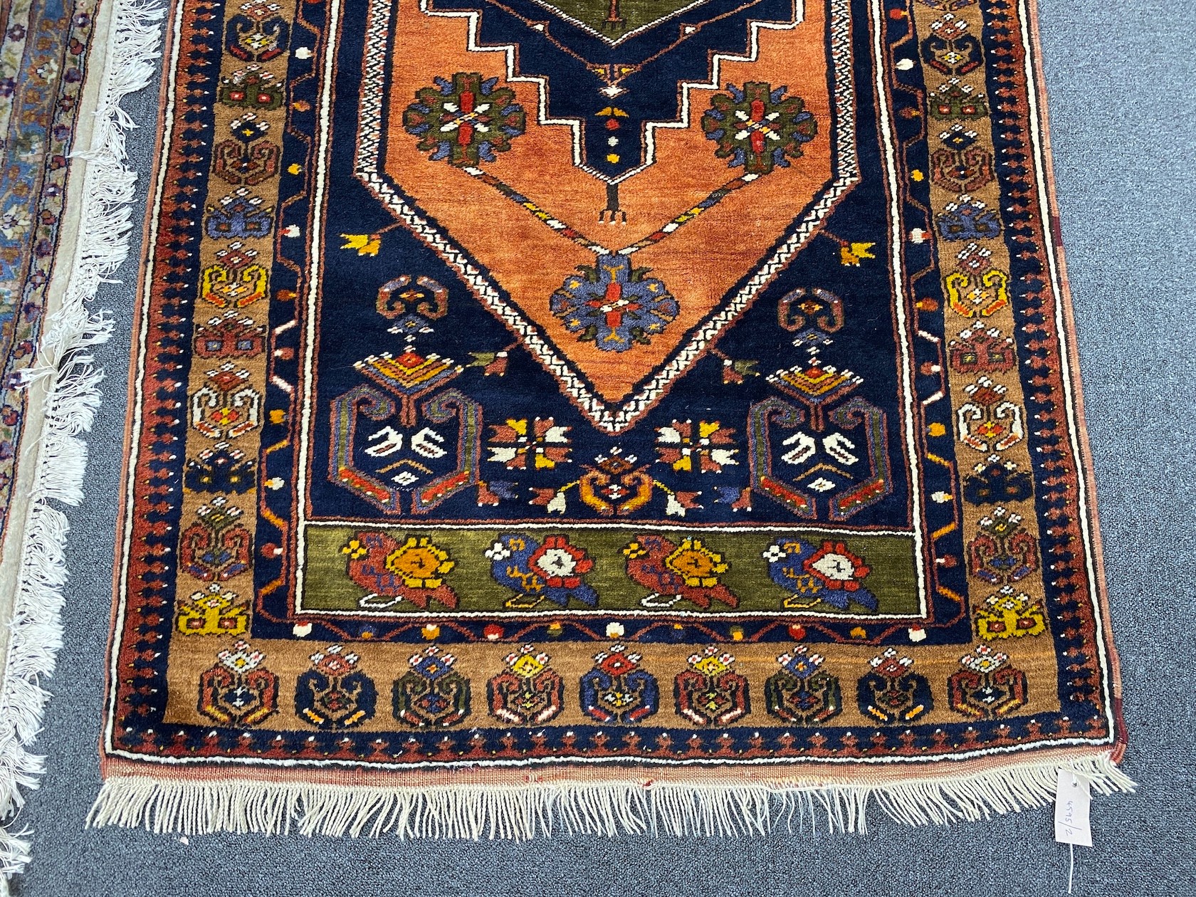 A Caucasian design blue ground rug, 204 x 104cm
